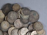 a pile of old coins sitting on a table