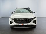 the front view of a white suv parked in a showroom