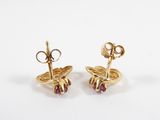 a pair of gold and ruby earrings