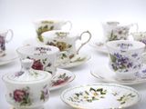 a lot of cups and saucers that are sitting on a table