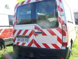 a red and white van parked in the grass