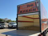 a truck that is parked in a lot with a sign on the back of it