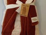towel wrapped in brown and white stripes with a tag on it