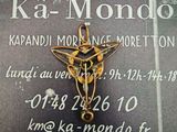 a gold cross with a star on it sitting on a plaque