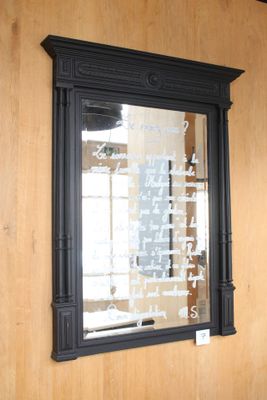 a mirror hanging on the wall with writing on it