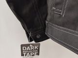 a close up of a black jacket with a tag on it