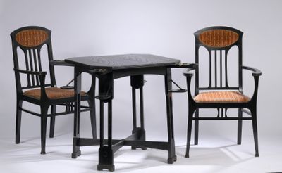 two chairs and a table that are sitting on a white surface
