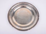 a silver plate on a white surface with a white background