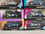 four boxes of assorted toy cars are stacked on top of each other