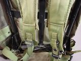 a close up of the back of a backpack with two guns attached to it