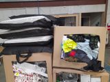 a pile of clothes sitting on top of a cardboard box