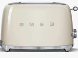 Grille-pain Smeg de couleur crème, portant l'inscription « Smeg »