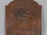 an old metal plaque with a woman holding a sword and a bird
