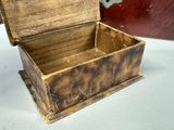 a small wooden box with a handle on a table