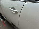 a close up of a car door handle with a sticker on it