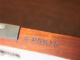 a close up of a wooden desk with a nameplate on it