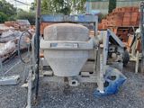 a concrete mixer that is sitting on the ground