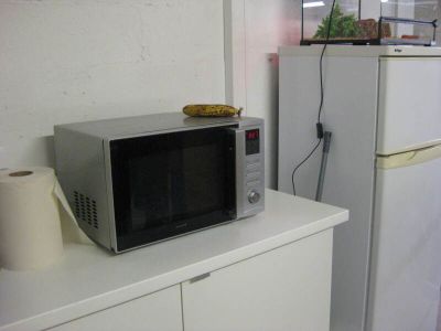 un four à micro-ondes posé sur un meuble blanc