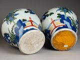 pair of blue and white vases with designs on them on a gray surface
