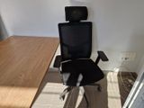 a desk with a chair and a computer on it