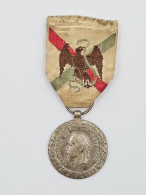 une vieille médaille avec un aigle au recto et une autre médaille au verso