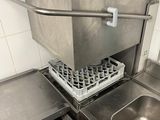a sink in a small kitchen with a dish rack
