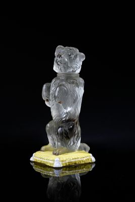 a glass figurine of a bear holding a banana
