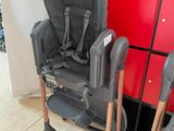 a baby chair that is sitting next to a red cabinet