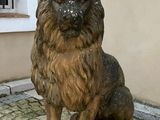 a statue of a lion sitting on a stone block