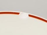 a close up of a plate with a red stripe on it