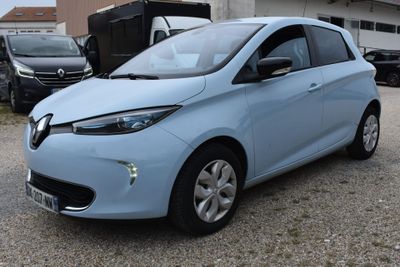 a picture of a blue car parked in front of a building