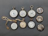 several different types of pocket watches are displayed on a table