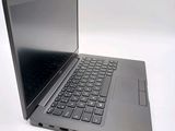 a silver laptop with a black keyboard on a white surface