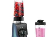 a blender with a blender and a blender with berries in it