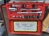 a red tool case with a set of tools in it