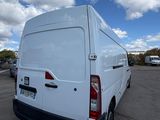 the rear end of a white van parked in a parking lot