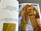 an open book with a picture of a coat on it