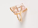 an image of a pink quartz ring on a white surface