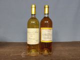 two bottles of wine that are sitting on a table