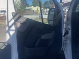 a white truck with its door open in a parking lot