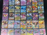 the collection of pokemon cards are displayed on a table