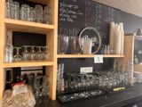 many glasses and jars on the shelves in the store