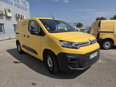 yellow citrole van parked in a parking lot next to other vans