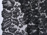 a close up of a black and white lace on a mannequin