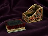 an image of a brush and brush holder sitting on a purple cloth