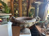 a large vase sitting on a pedestal in the middle of a room