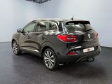 the rear end of a grey car in a showroom