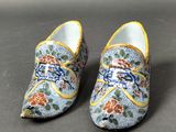 pair of blue and yellow clogs with flowers on them