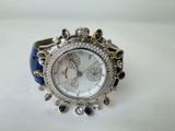 a close up of a watch on a white surface