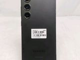 the back of a black samsung phone with a barcode sticker on it